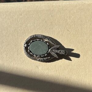 a vintage Miracle Celtic pendant or brooch with a central stone and silver-tone